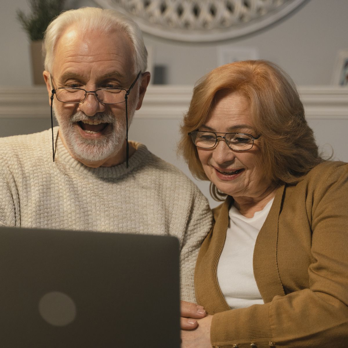 A happy older couple smiling together at home